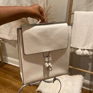 Medium White purse with straps that you can use like a backpack. It’s from Zara.